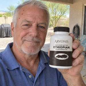 Arvonis customer holding Arvonis Ethiopian Blackseed Oil